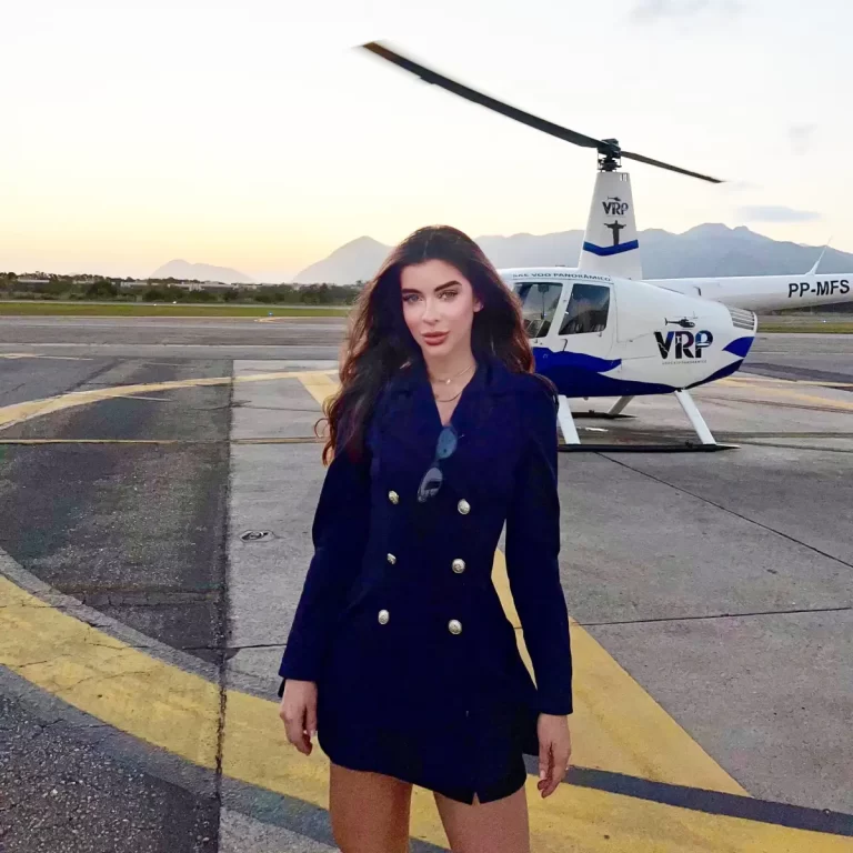 VRP Helicopter Rio 4 a woman in a dress standing in front of a helicopter